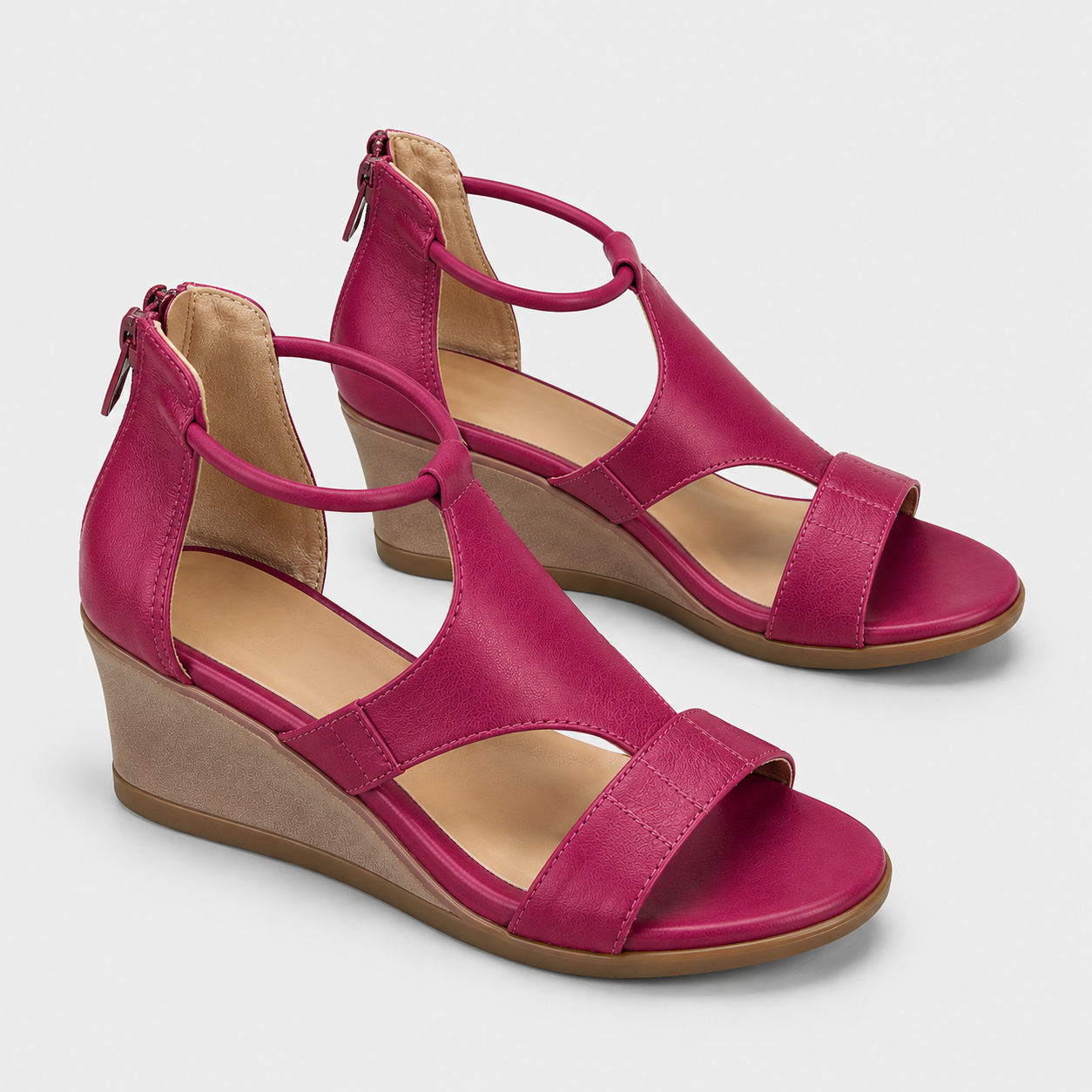 A pair of women's wedge sandals in a vibrant magenta pink, featuring open toe straps, side zippers, and tan wedge heels, shown on a light gray background.