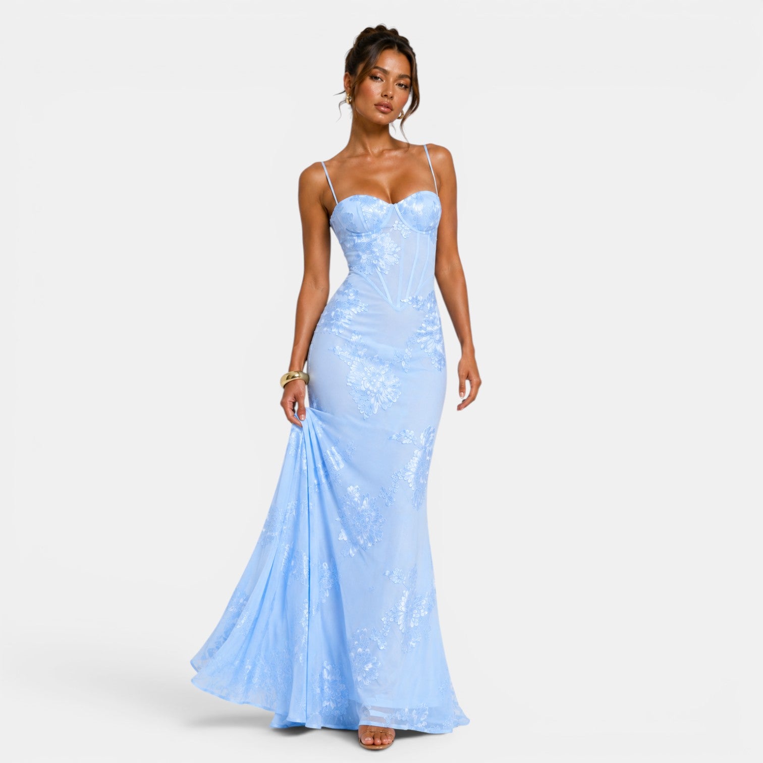 Woman wearing a light blue sequin dress on a white background