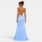 Woman wearing a light blue evening gown with a backless design on a white background