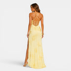 Woman wearing a yellow dress with a backless design on a white background