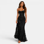 Woman wearing a black evening gown on a white background