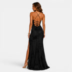 Black evening gown with open back and side slit on a white background