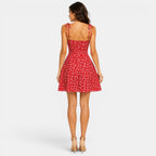 Woman wearing a red floral dress on a white background