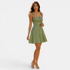 Woman wearing a green floral dress on a white background