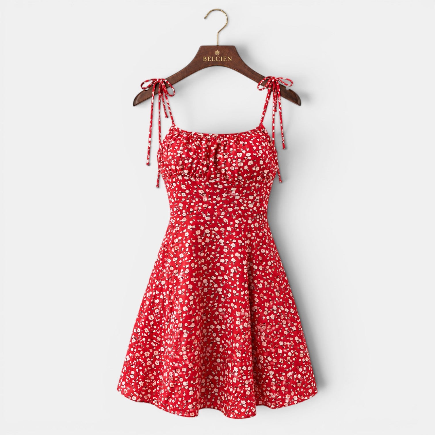 Red floral dress on a hanger with 'BELCION' branding against a white background