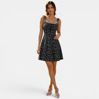 Woman wearing a black floral dress on a white background