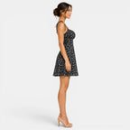 Woman wearing a black floral dress on a white background
