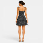 Woman wearing a black floral dress on a white background