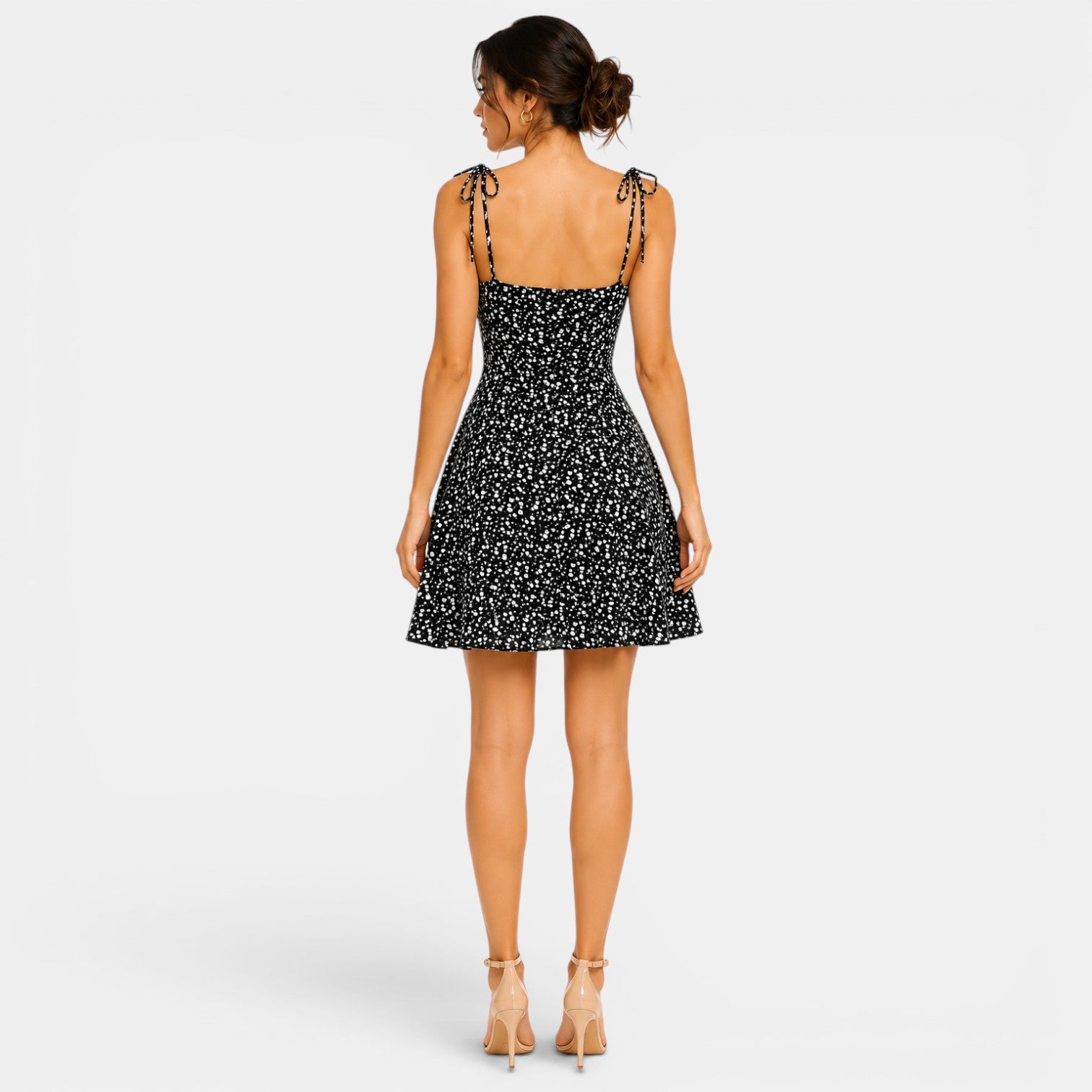 Woman wearing a black floral dress on a white background