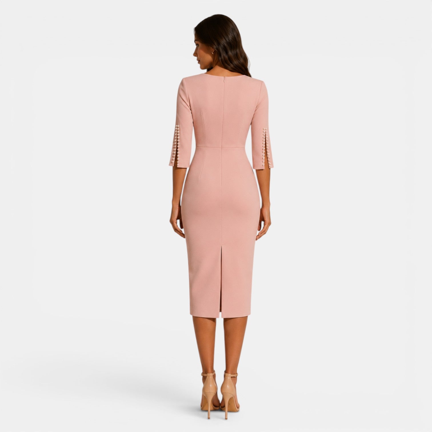 Woman wearing a pink dress with cut-out sleeves on a white background