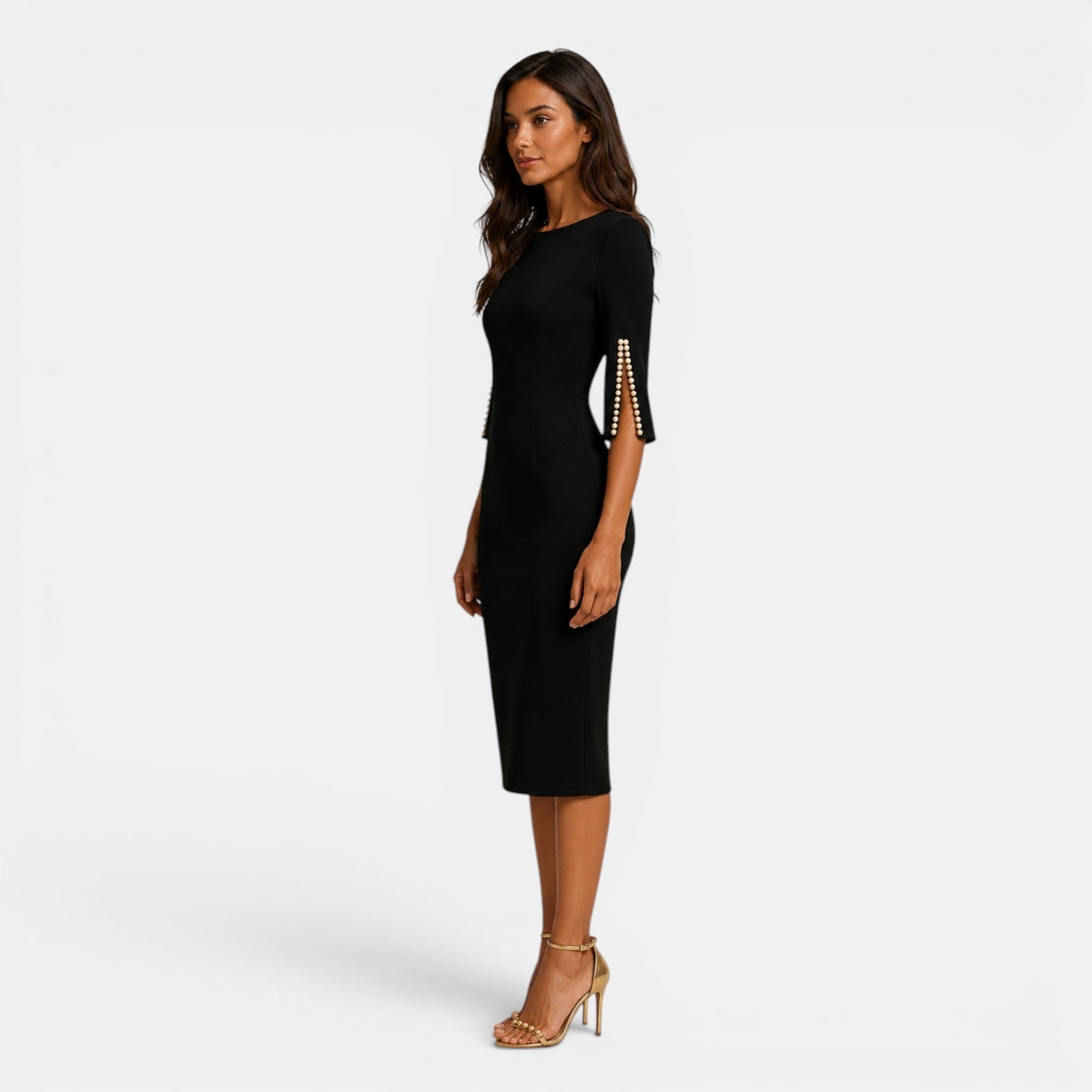 Woman wearing a black dress with gold accents on a white background