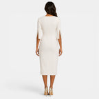 Woman wearing a white dress with cut-out sleeves on a white background