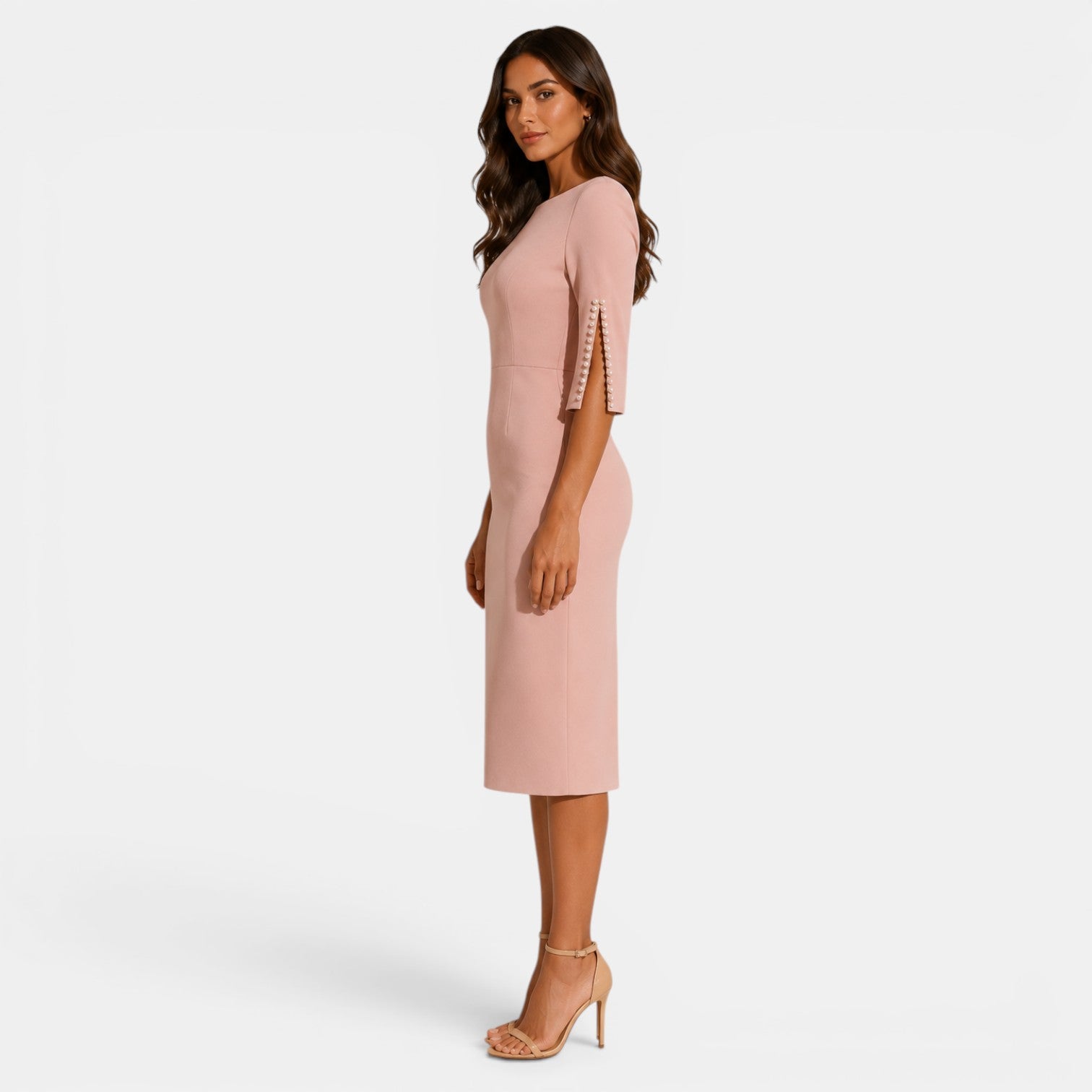 Woman wearing a pink dress with ruffled sleeves on a white background