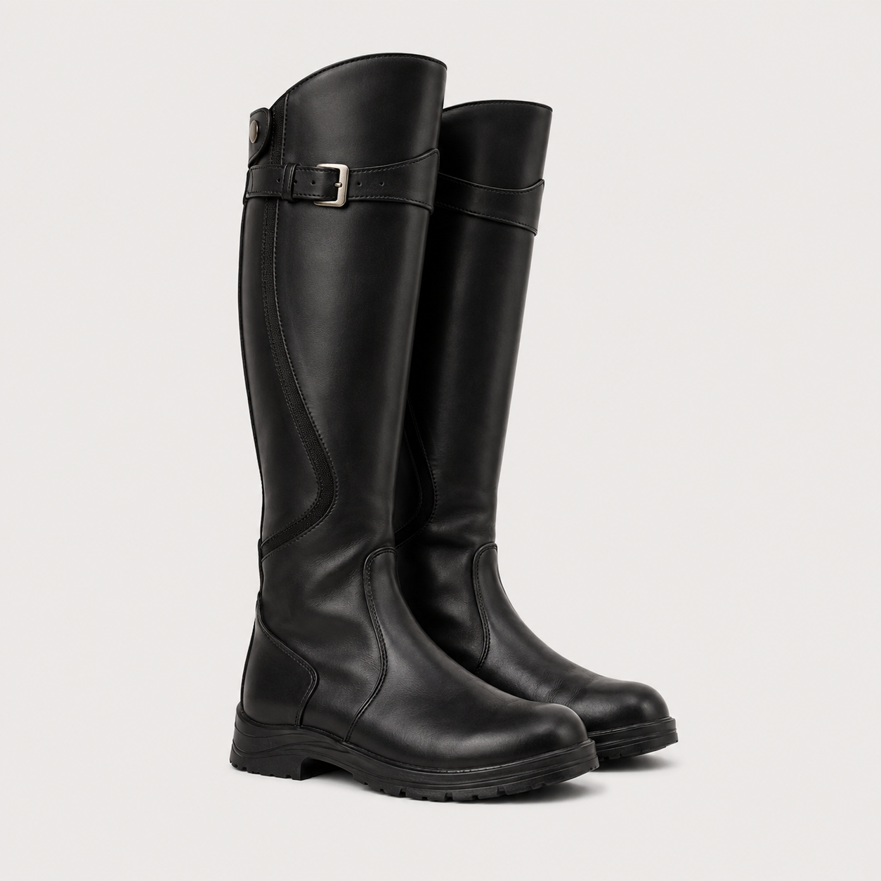 Black knee-high boots with ruched design on a light gray background