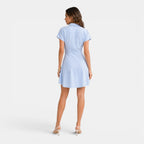 Woman wearing a light blue dress on a white background