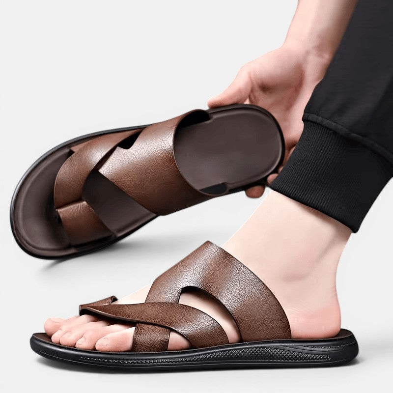 Brown sandals being worn on a light gray background