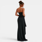 Woman wearing a black strapless gown on a white background