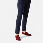 Navy pants with red loafers on a white background