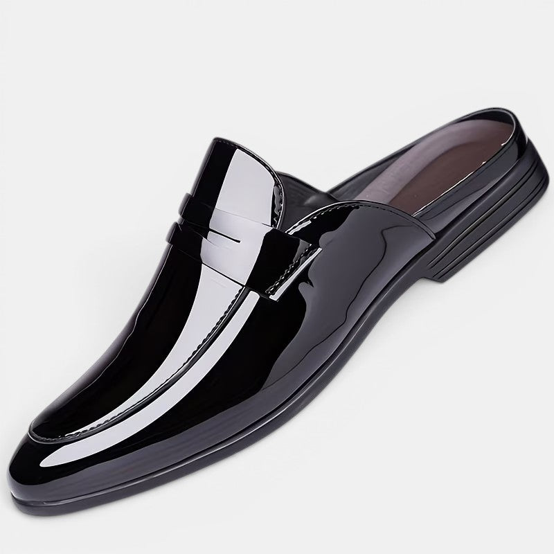 Shiny black loafer on a light gray background