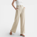 Beige wide-leg pants worn by a person on a white background