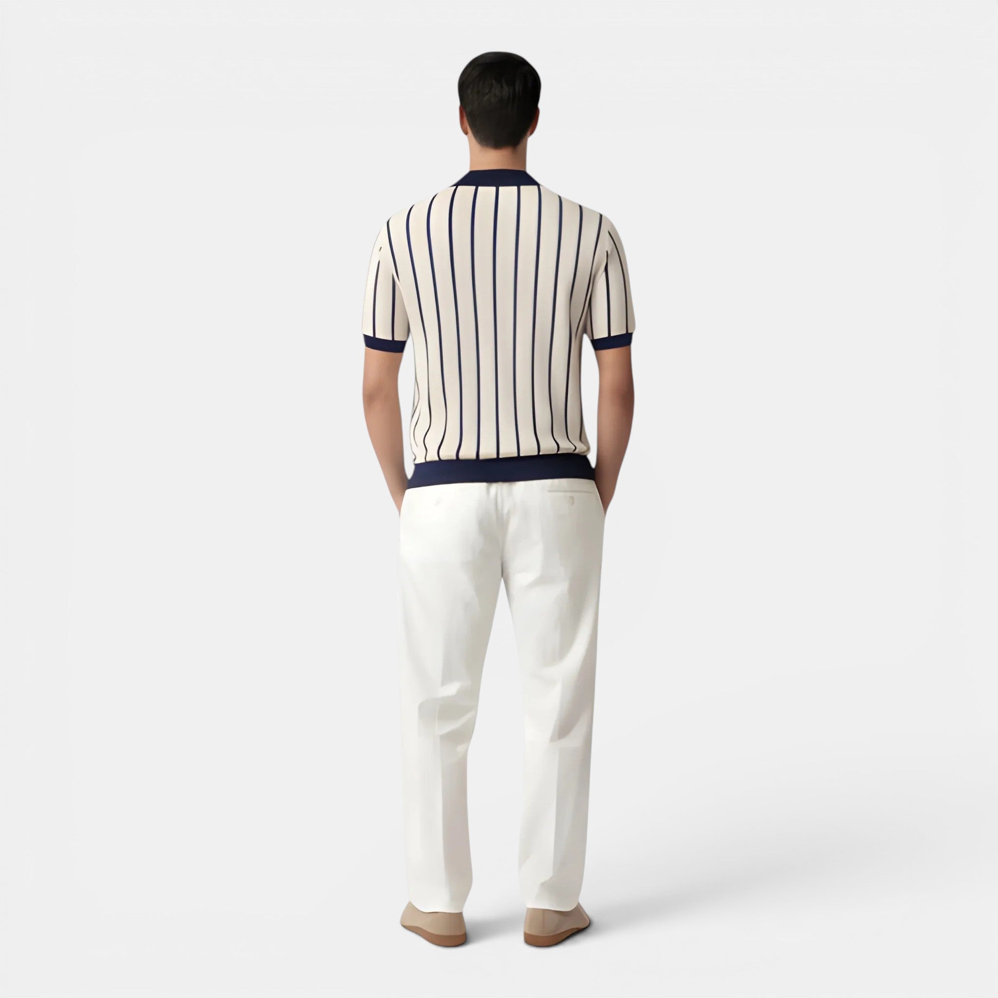 Man wearing a striped shirt and white pants on a white background