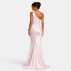 Woman wearing a pink one-shoulder gown on a white background
