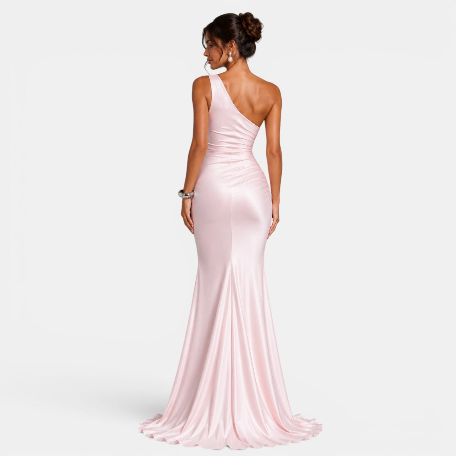 Woman wearing a pink one-shoulder gown on a white background