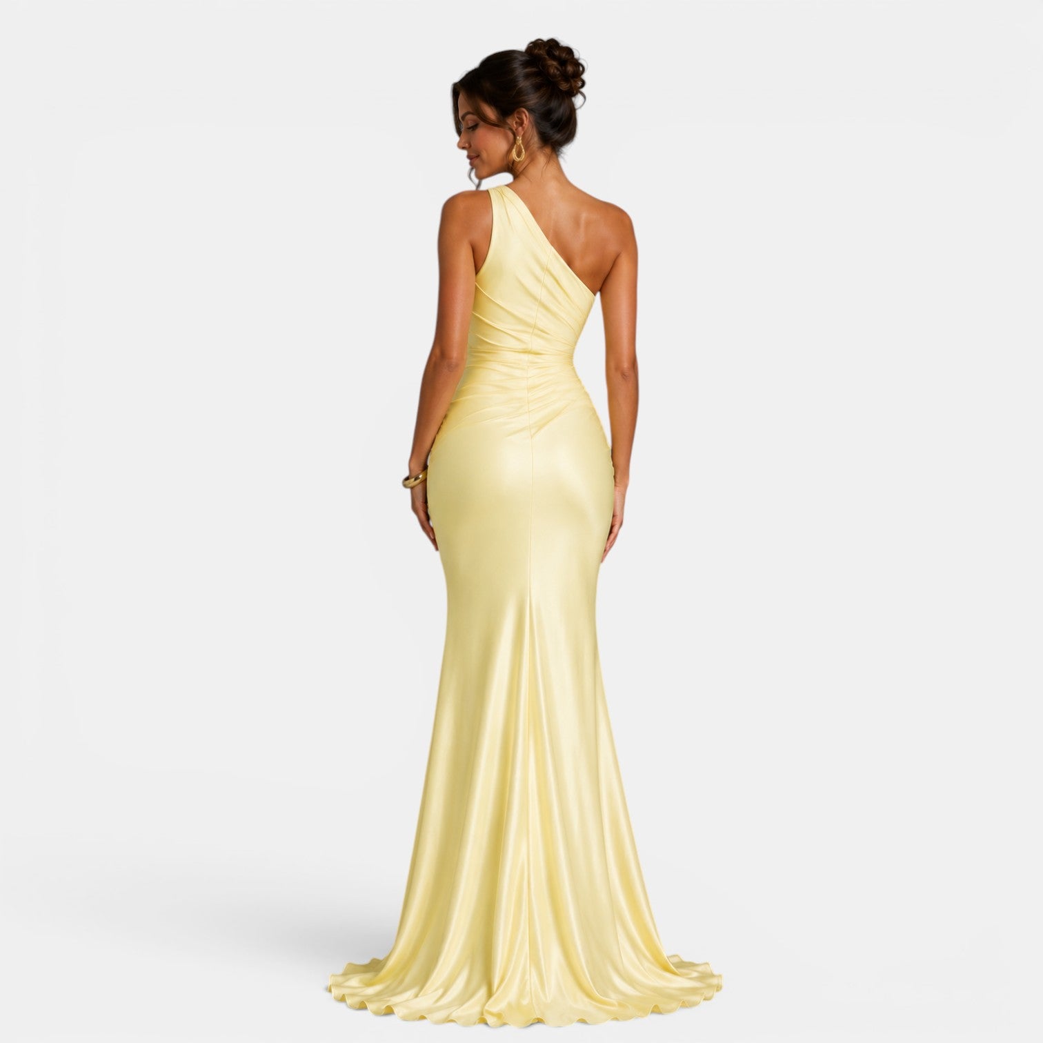 Woman wearing a light yellow one-shoulder gown on a white background