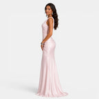 Woman wearing a pink evening gown on a white background