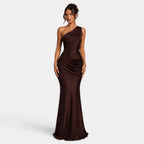 Woman wearing a brown one-shoulder evening gown on a white background
