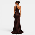 Woman wearing a brown one-shoulder evening gown on a white background