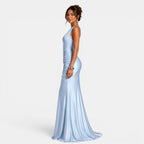 Woman wearing a light blue evening gown on a white background