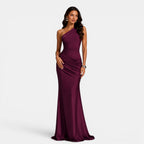 Woman wearing a one-shoulder burgundy gown on a white background