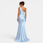 Woman wearing a light blue one-shoulder gown on a white background