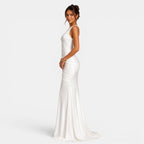 Woman wearing a white evening gown on a light gray background