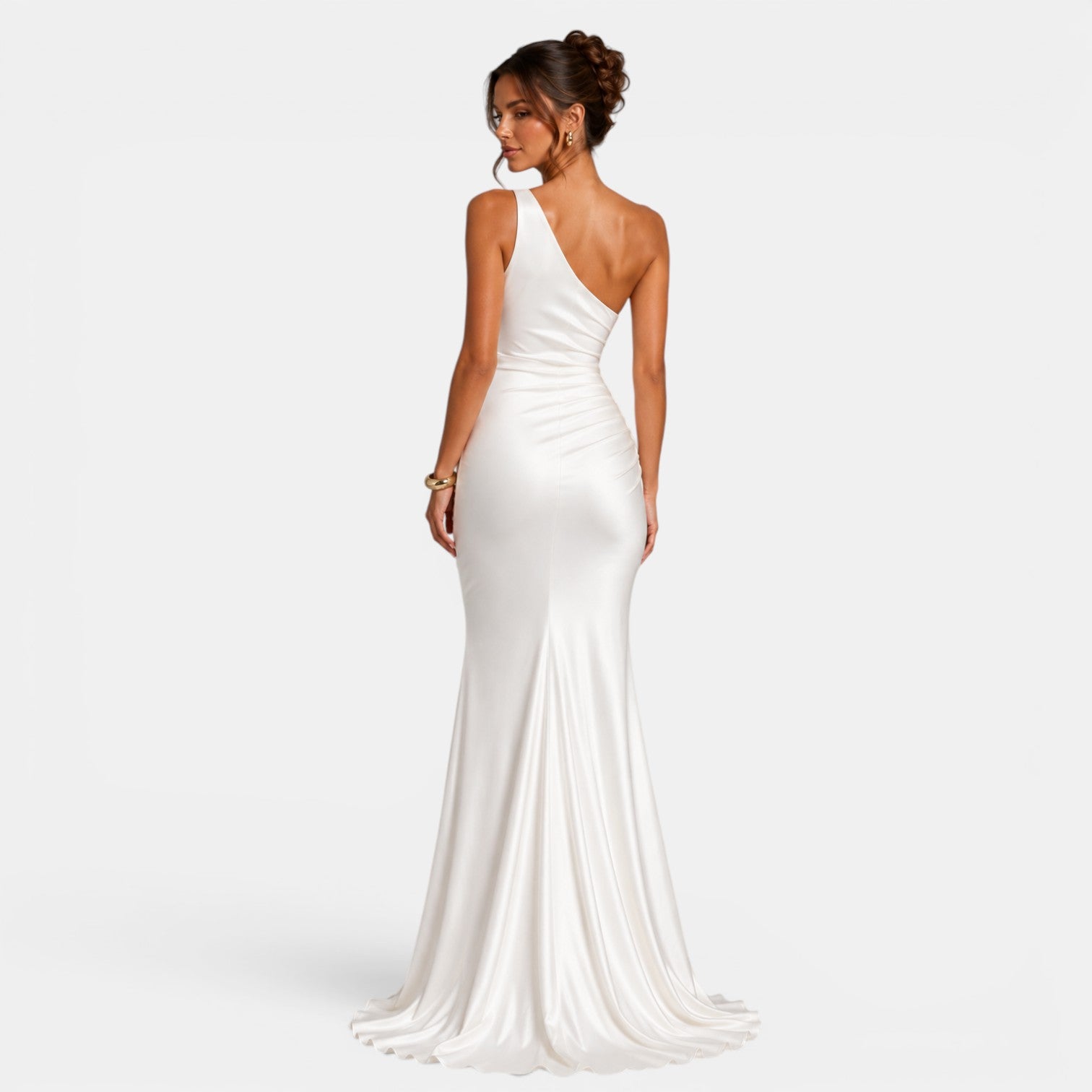 Woman wearing a white one-shoulder gown on a light gray background