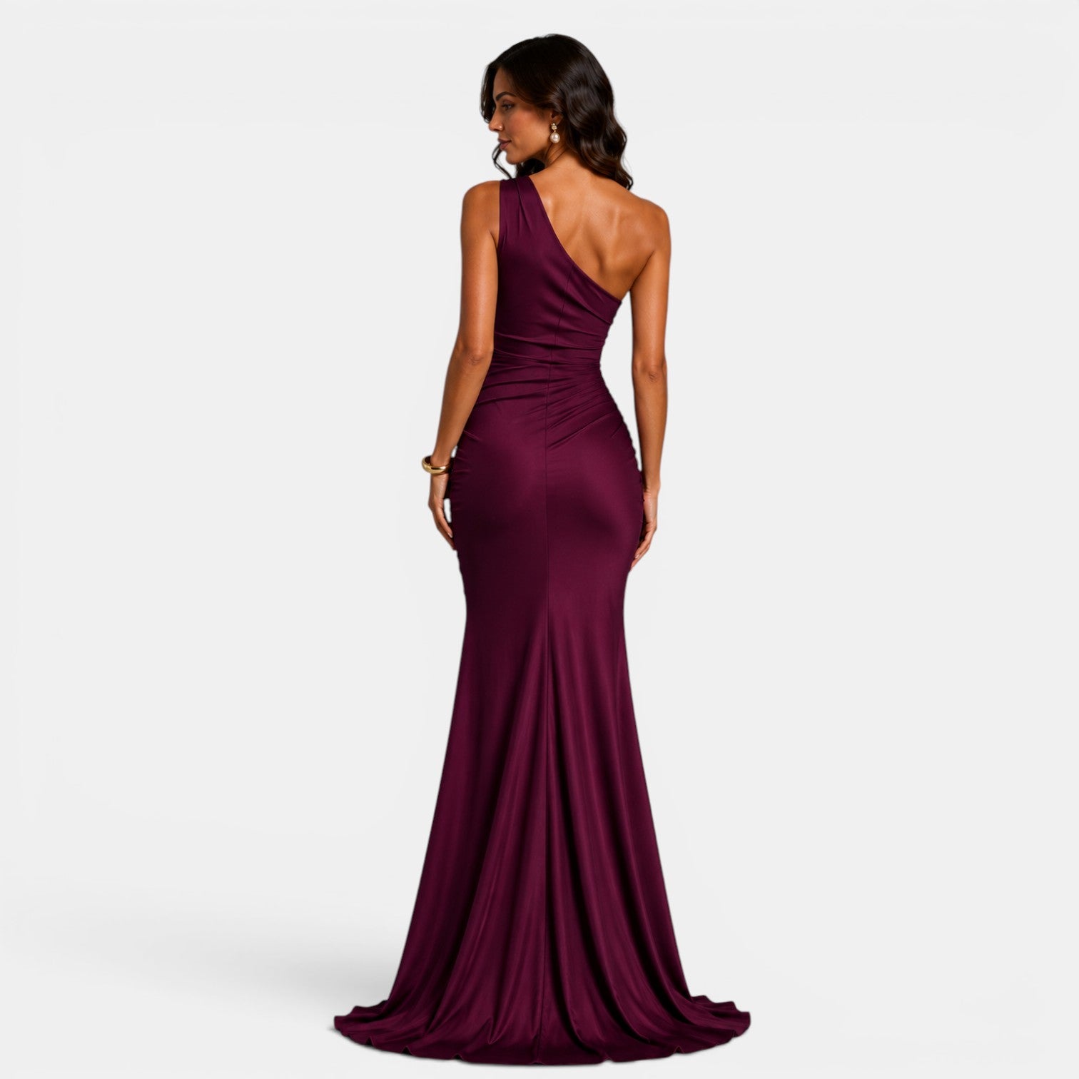 Woman wearing a burgundy one-shoulder gown on a white background