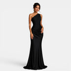 Woman wearing a black one-shoulder gown on a white background
