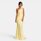 Woman wearing a yellow one-shoulder gown on a white background