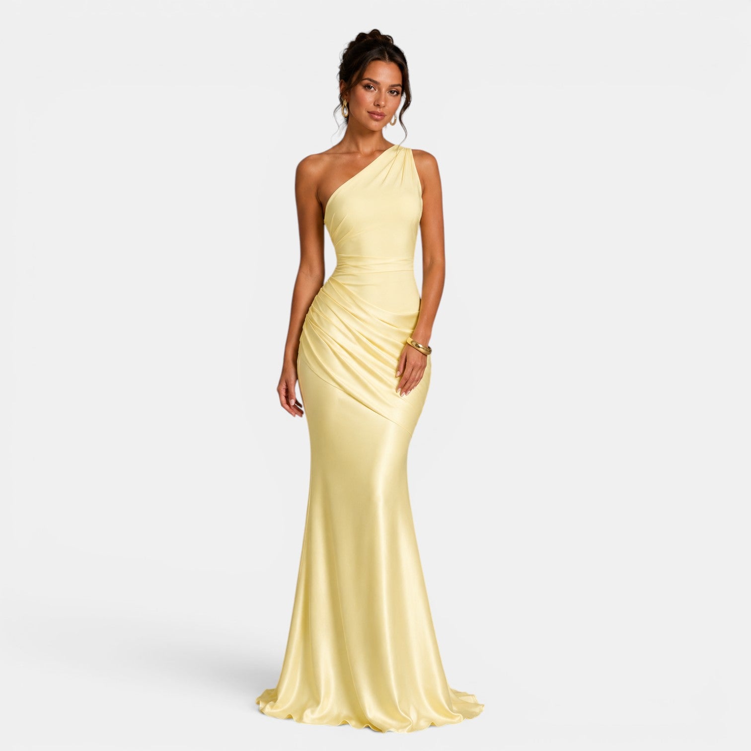 Woman wearing a yellow one-shoulder gown on a white background