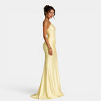 Woman wearing a light yellow evening gown on a white background