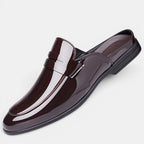 Shiny brown loafer shoe on a light gray background