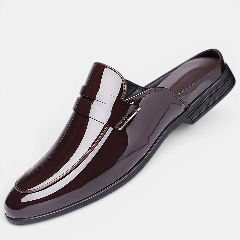 Shiny brown loafer shoe on a light gray background