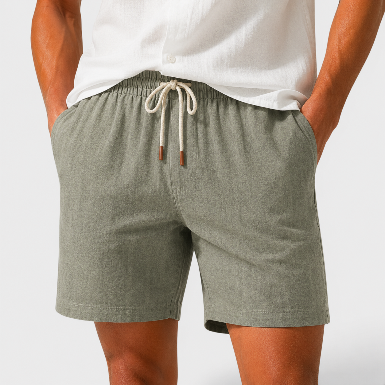 Person wearing green shorts with a white background