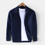 Navy blue ribbed sweater on a hanger against a white background