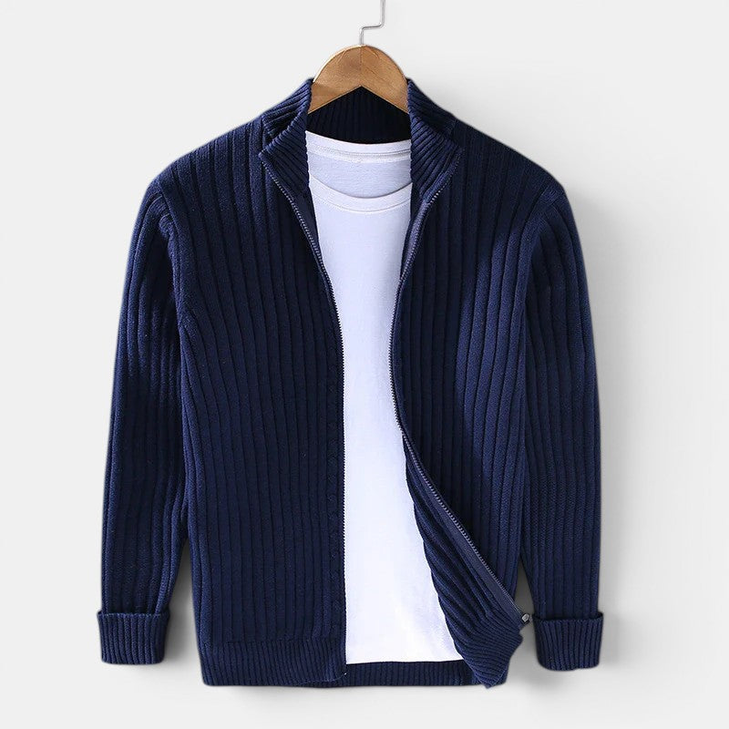 Navy blue ribbed sweater on a hanger against a white background