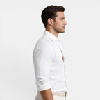 Man wearing a white dress shirt on a light gray background