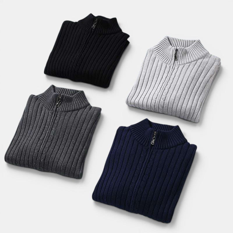 Four folded ribbed knit quarter-zip sweaters in black, gray, and navy on a white background.