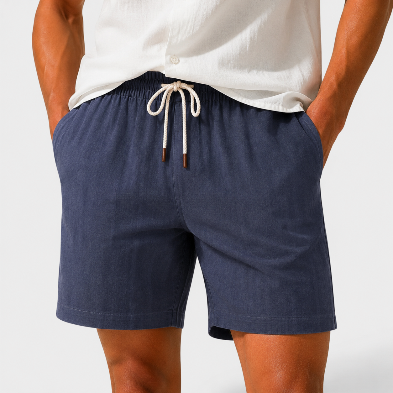 Navy shorts with a drawstring worn by a person on a white background