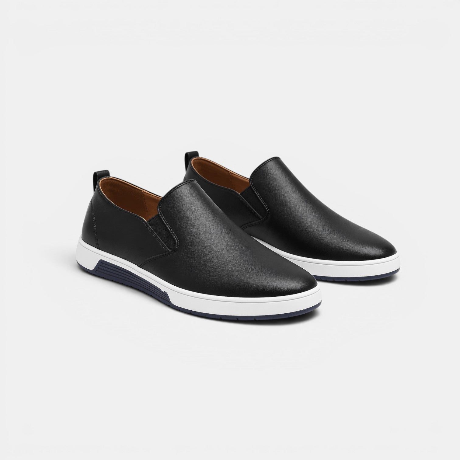 Pair of black slip-on shoes on a light gray background